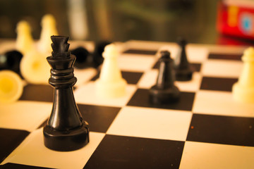 Chess battle. Plastic chess pieces. White background. Two-player strategy board game