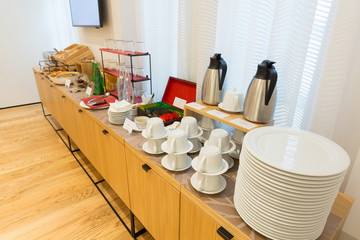 Breakfast, coffee and tea, ready to be served on buffet table