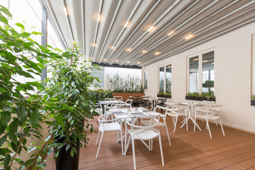 Beautiful restaurant summer terrace interior with moving roof