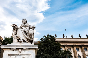 Obraz premium White statue near Humboldt University in Berlin, Europe. Monument against blue sky with white clouds