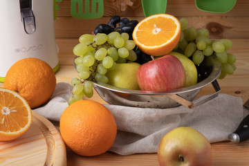 Fresh fruits on a wooden background, cutting wooden board and knife