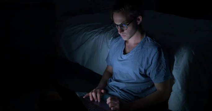Male working on his laptop late at night