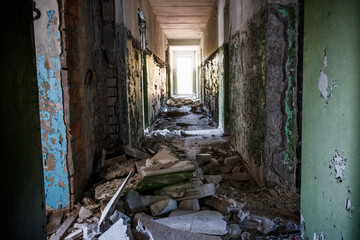 Fototapeta na wymiar Long corridor of ruined abandoned house