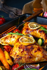 Grilled chicken legs with various vegetables and herbs.