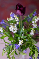 bouquet of spring flowers with lilies of the valley, periwinkle and Tulip Selective focus