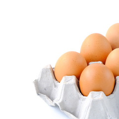 Close-up top view of organic raw eggs on white background with copy space for your text, healthy eating concept.