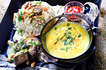 Traditional arabic rice and lamb plate with sauce.