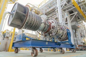 Fototapeta Turbine engine of gas compressor on offshore oil and gas central processing platform removed from enclosure to maintenance and service. obraz