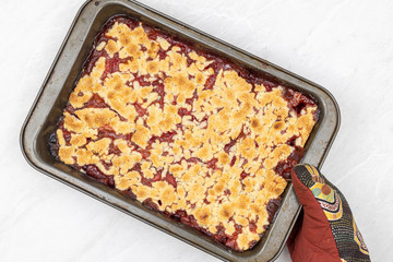 Top view of Strawberry cake baked in the baking tray on the grey marble table