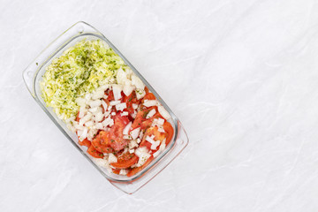 Top view of salad with tomato cucumber and onions with copy space