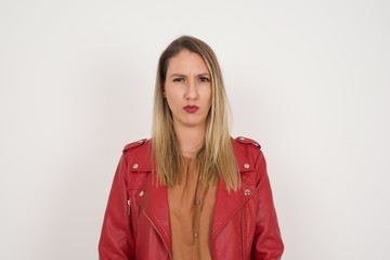 Obraz premium Portrait of outraged young woman with oval face, frowning her eyebrows being displeased with something.
