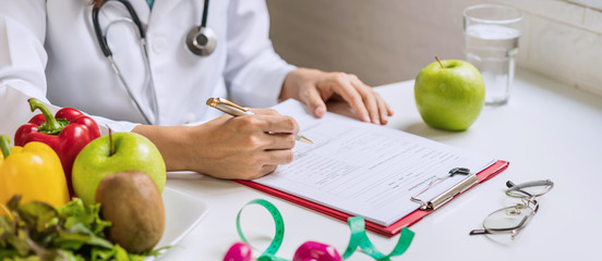 Nutritionist giving consultation to patient with healthy fruit and vegetable, Right nutrition and...