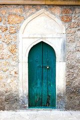 Authentic old door in Arabic style in a stone wall, in minimal style, bright colors, background.