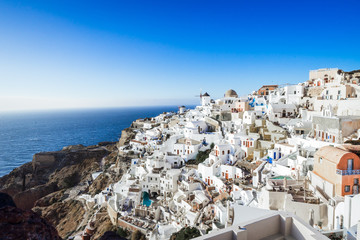 Fototapeta na wymiar view of Oia and its typical architecture with windmill, Santorini island, Cyclades, Greece