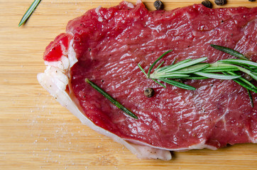 steak, rosemary and salt on a serving board