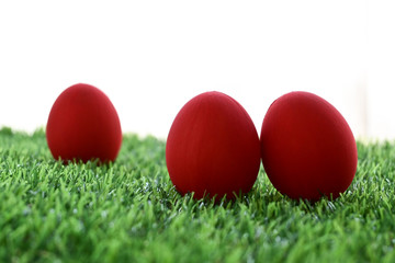 red easter egg on lawn green grass artificial with blank white background