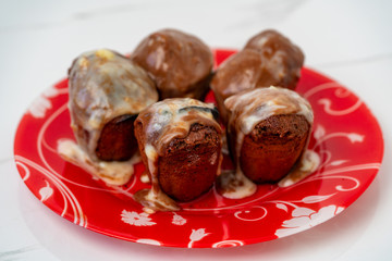 Four muffins with chocolate cream on a yellow background