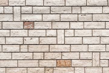 Real wall made of light grey brick background textured