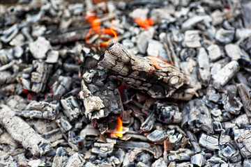Texture embers closeup. Embers after a fire. Details of charcoal for barbecue at picnic.