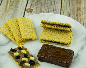 Homemade granola bars with peanut chocolate spread and raisins for chocolate