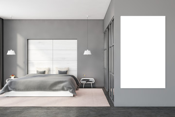 Gray and white bedroom with vertical poster
