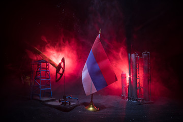 Business dialogue, oil agreement concept: National flags with Oil pump and oil refining factory at...