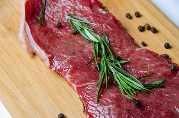 steak, rosemary and salt on a serving board