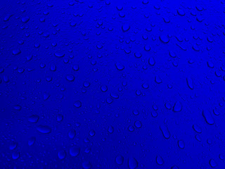 Drops of water on a blue metal surface, beautiful background after rain