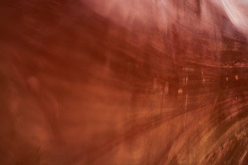 Background or texture of smooth and embossed red natural stone.