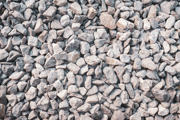 Gravel texture. Pebble stone background. Light grey closeup small rocks. Top view of ground gravel road.