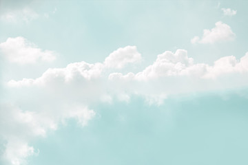 Light soft mint color sky with delicate white clouds