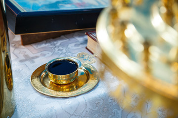 Church wine in a golden bowl. Religious traditions