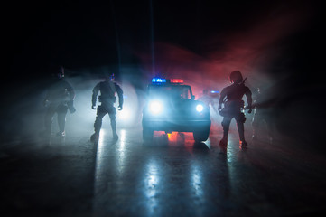 Police cars at night. Police car chasing a car at night with fog background. 911 Emergency response police car speeding to scene of crime. Selective focus © zef art