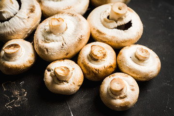 Freshly harvested mushrooms on the rustic wooden background. Selective focus. Shallow depth of field.
