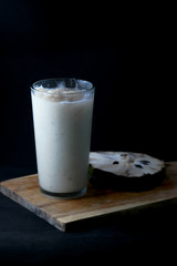 Sour sop juice in glass with black background
