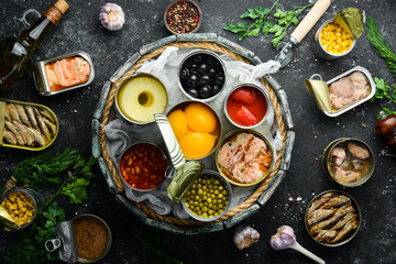 Food stocks. Food in tin cans. Vegetables, fruits, fish, meat and legumes are marinated in jars.