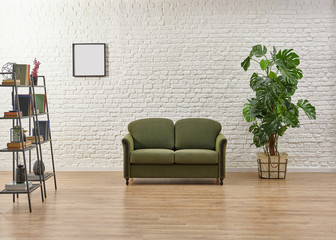 White brick wall green sofa and frame living room.