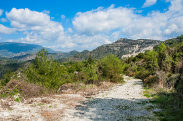 Light clouds cast fancy shadows on the peaks and slopes of the Troodos Mountains. Shadows creep from mountain to mountain, changing their shape.         