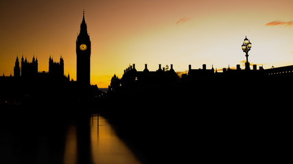 Silhouette view of the Houses of Parliament and the Big ben Tower in London with a yellow sky at...