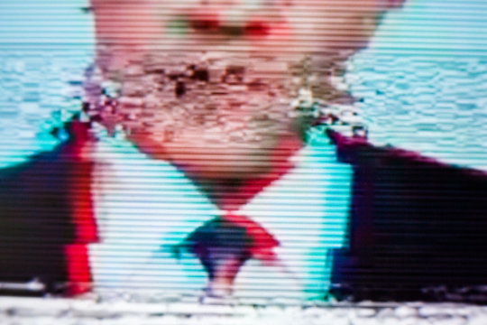 Man in a suit on the screen. Glitch.