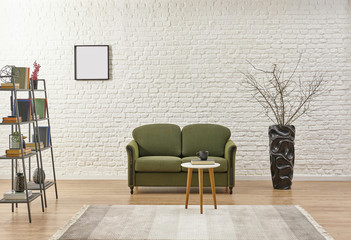 White brick wall green sofa and frame living room.
