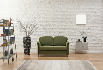 White living room concept, brick detail background and green armchair.
