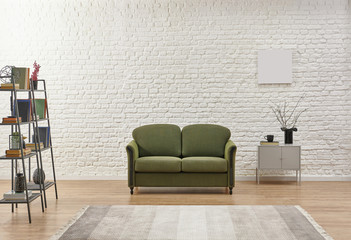 White living room concept, brick detail background and green armchair.