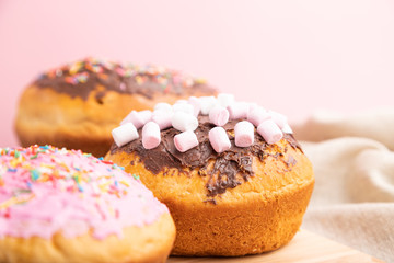 Homemade glazed and decorated easter pies on a gray wooden background and linen textile. Side view, selective focus, close up.
