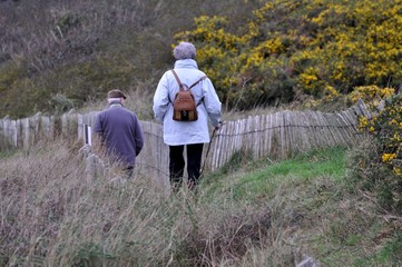 A couple of retired people who is walking on a path in Brittany. France
