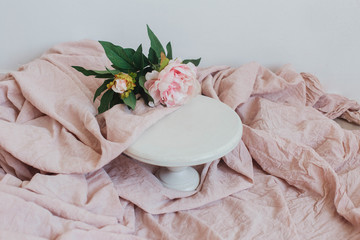 pink rose in a white wooden cake stand 