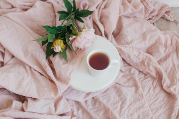 flowers and cup of tea on wooden background
