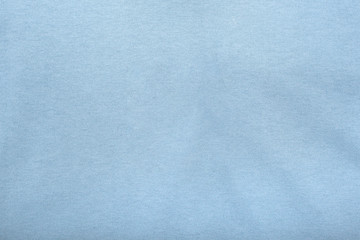 Abstract blue fabric texture background. Creases of pastel blue color cotton.