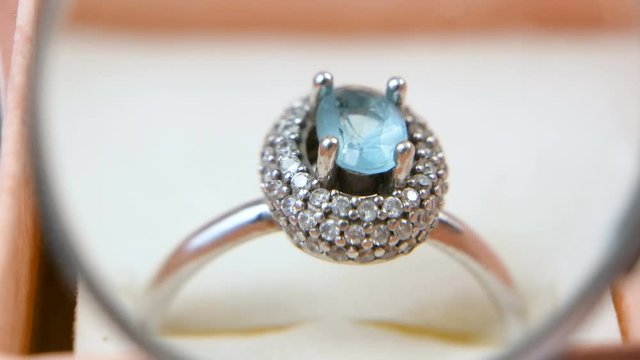 jeweler looking at jewelry through magnifying glass, jewerly inspect and verify, pawnshop concept, jewerly shop concept