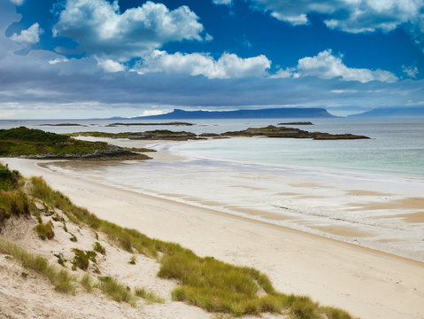 With the islands of Eigg and Rum on the horizon, a view across Camusdarach Beach on the west coast of Scotland - the beach featured  in the film Local Hero